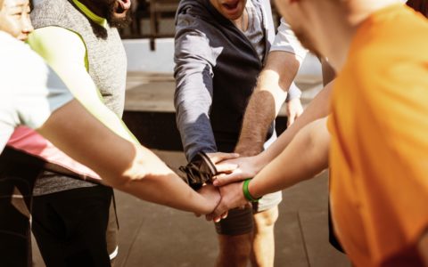 group of people touching fists
